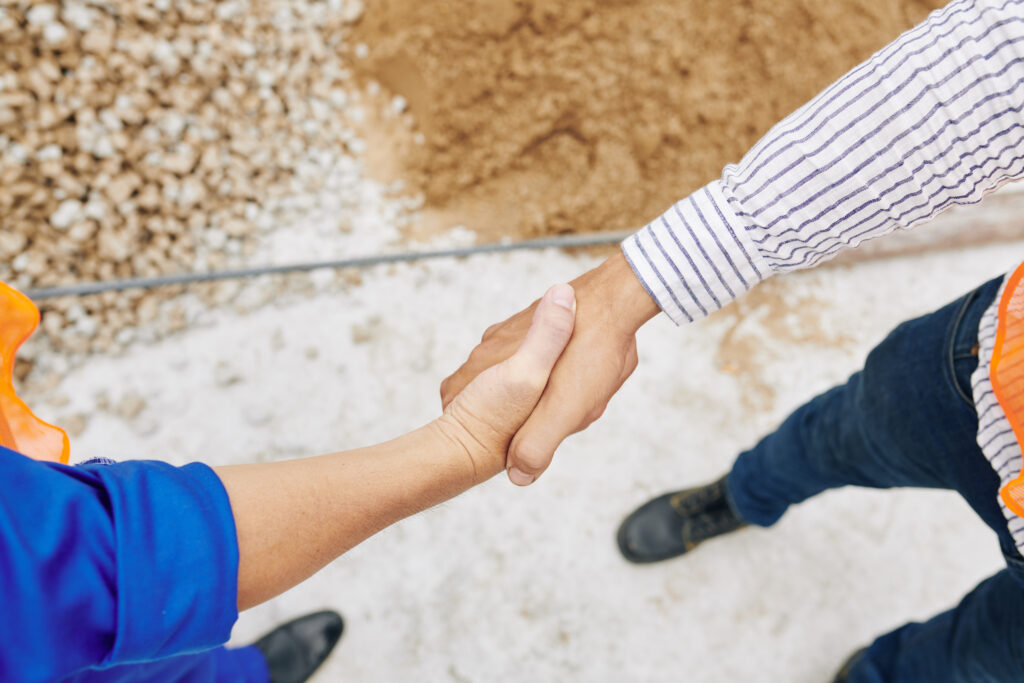 Contractor and builder shaking hands